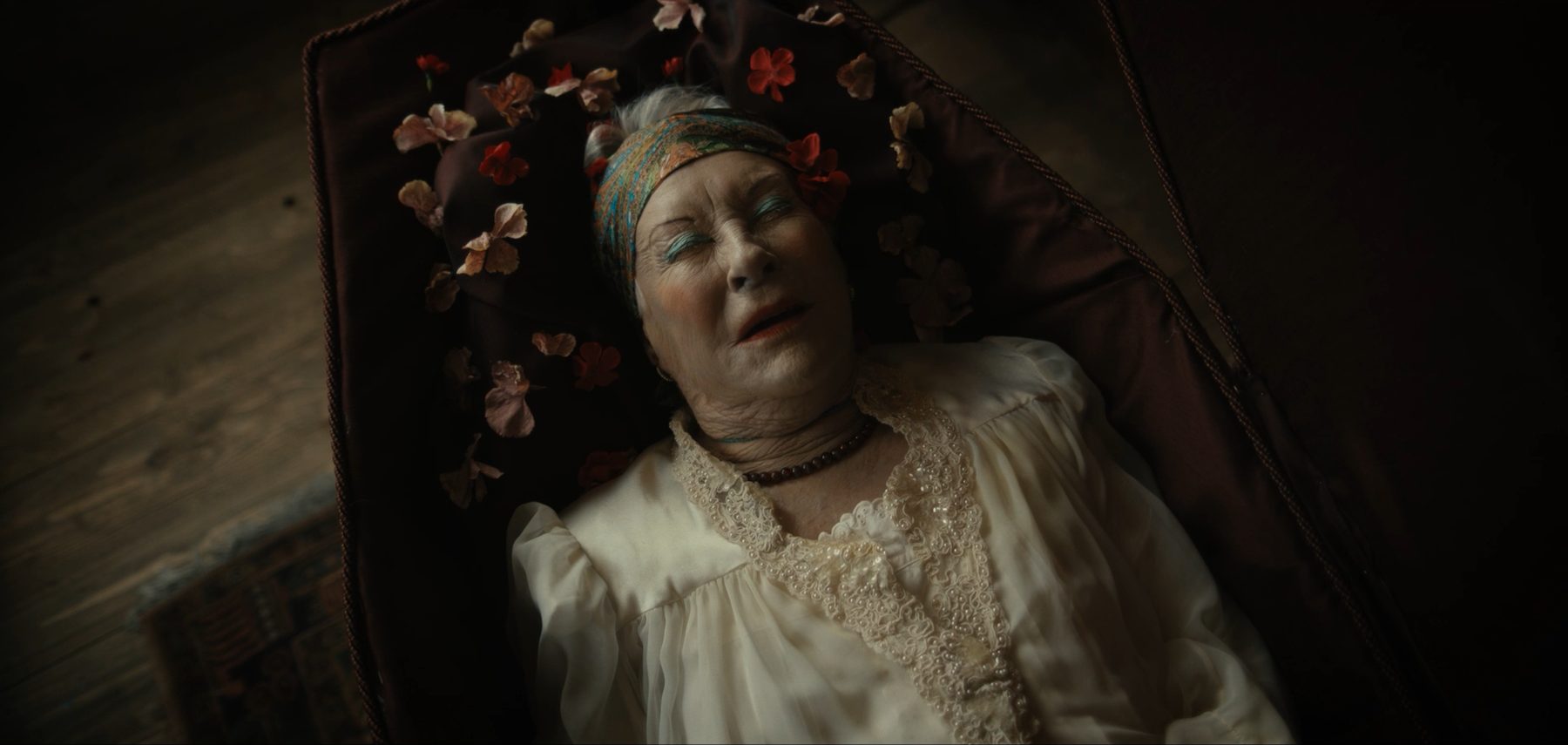 Grandmother laid out among flowers